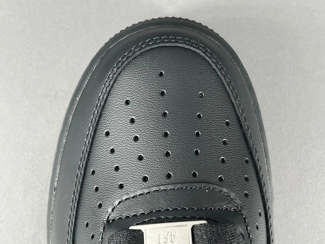 Nike Air Force 1 Black with classic silhouette, smooth leather upper, and all-black finish