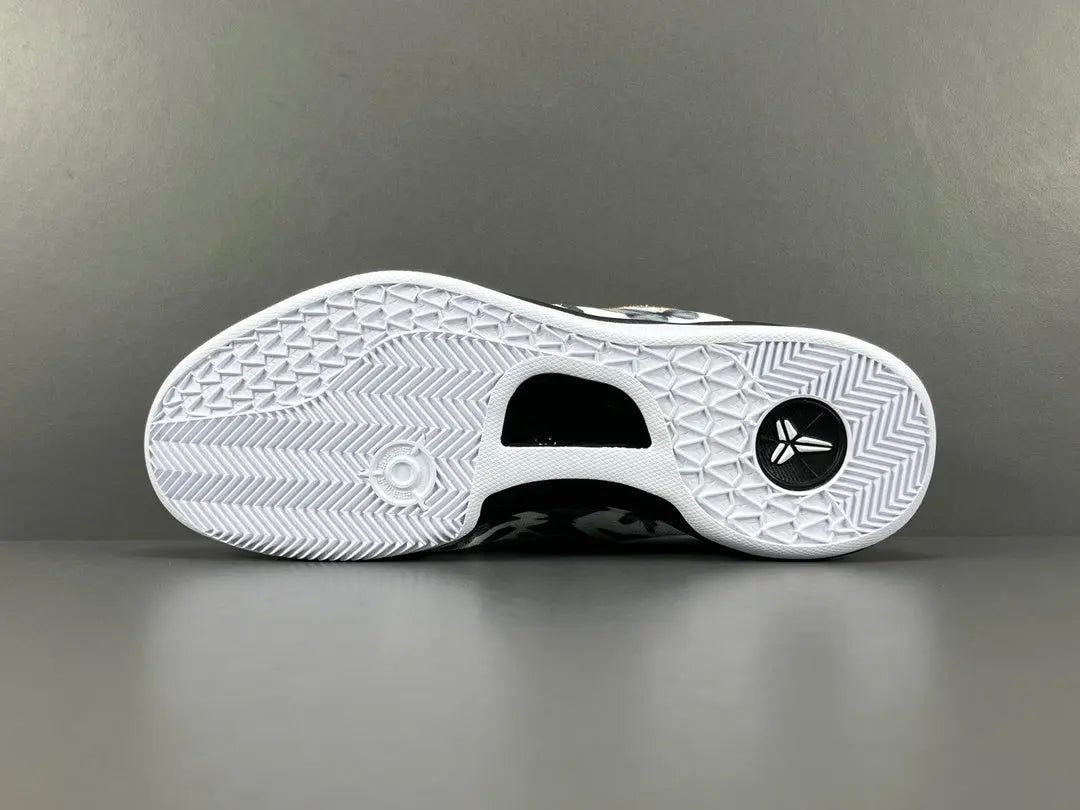 Close-up of a white sneaker sole with black accents on a gray background