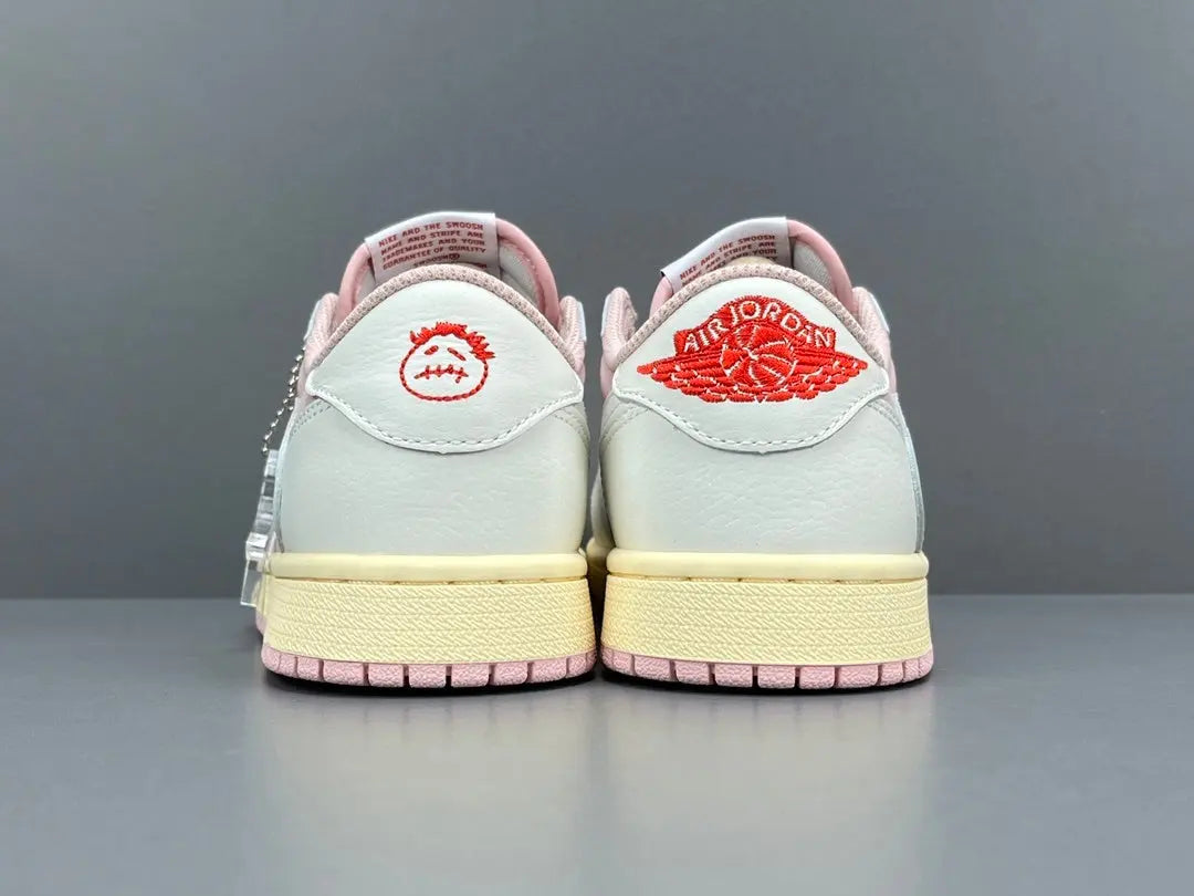 Jordan 1 Low x Travis Scott Shy Pink sneakers with reversed Swoosh design