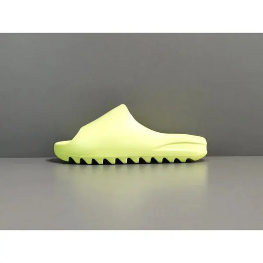 "adidas Yeezy Slide x Glow Green – vibrant neon-green slide with soft EVA foam, minimalist design, and ridged outsole for comfort and traction."