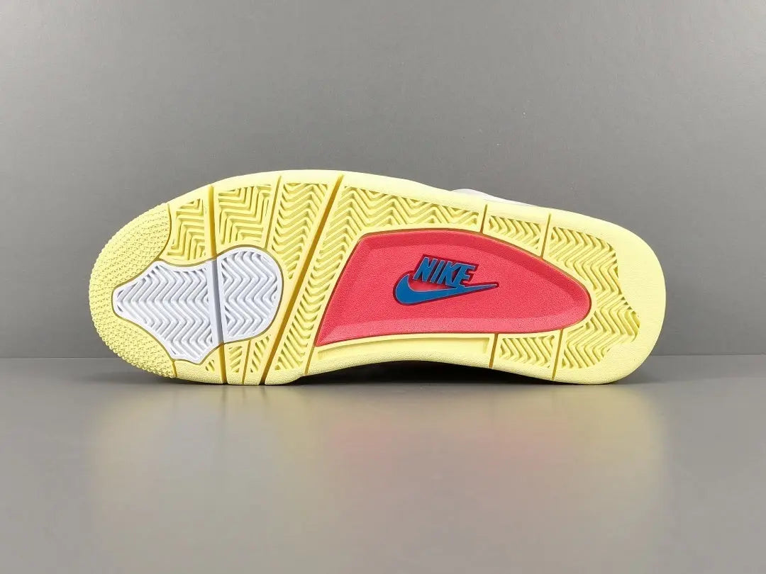 Close-up of a yellow and red Nike sneaker sole on a gray background