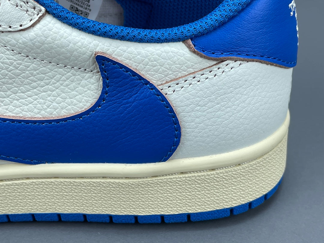 Air Jordan 1 Low OG x Travis Scott x Fragment with a white, black, and blue design, reverse Swoosh, and co-branded heel logos.