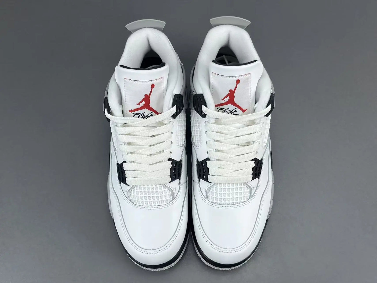 Air Jordan 4 White Cement sneakers with iconic cement print and design
