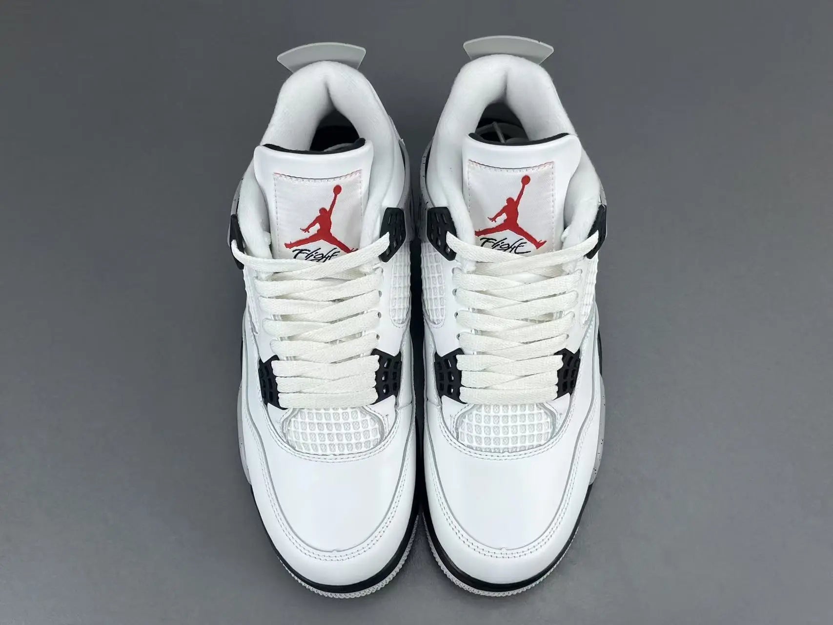 Air Jordan 4 White Cement sneakers with iconic cement print and design
