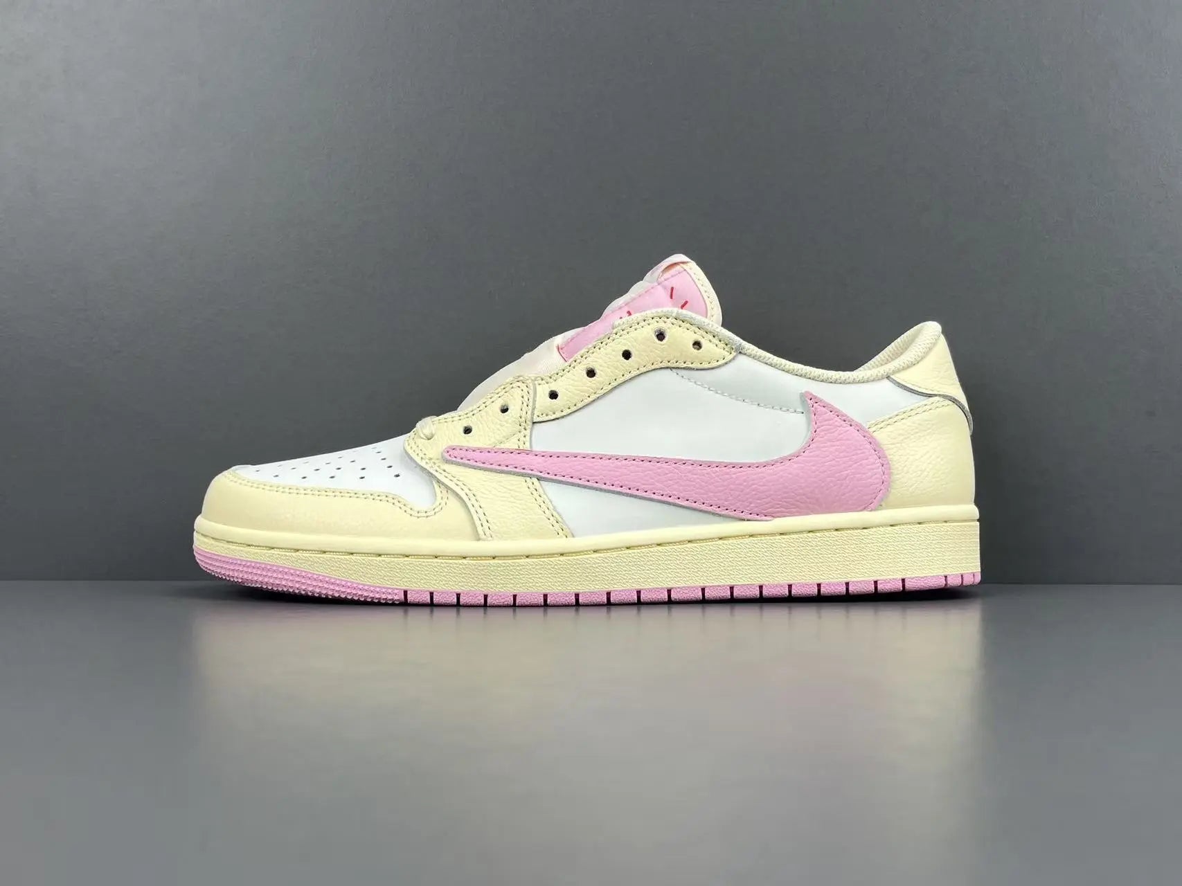 Jordan 1 Low Travis Scott Muslin Shy Pink sneakers with reverse Swoosh

