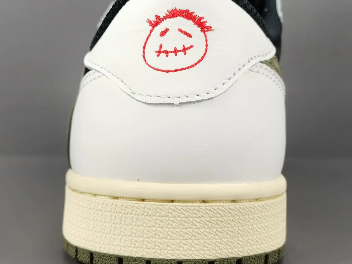 "Jordan 1 Low x Travis Scott Olive with olive suede, black leather overlays, reverse Swoosh, and Cactus Jack branding."
