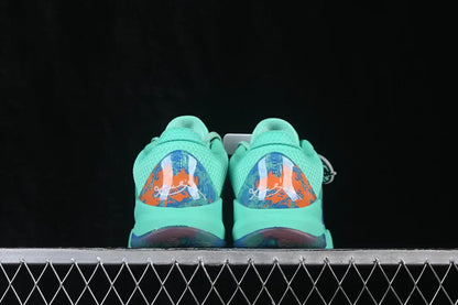 A pair of mint green and orange basketball sneakers shown from the back, resting on a metal grid against a black background.