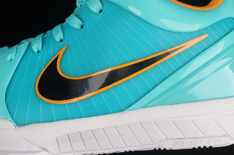 Close-up of a Nike sneaker in turquoise with a black Swoosh outlined in orange, a white sole, and turquoise laces against a black background.