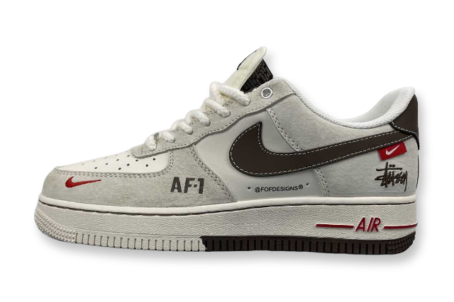 Gray sneaker with black and red accents on a white background