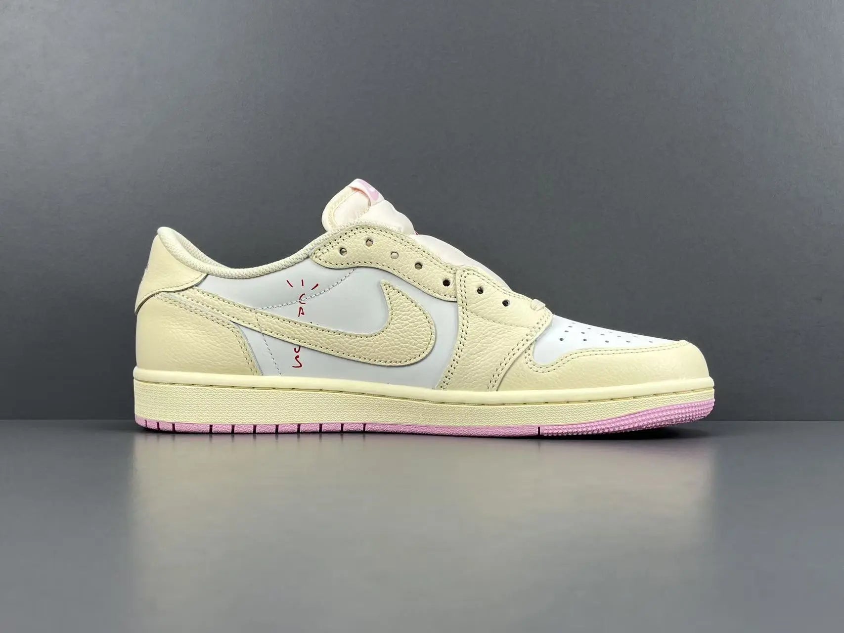 Jordan 1 Low Travis Scott Muslin Shy Pink sneakers with reverse Swoosh
