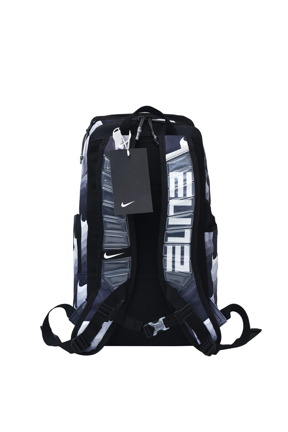 Nike athletic backpack shown from the back, featuring a black, gray, and white patterned design with large vertical white text and a black hangtag with a white Nike swoosh.