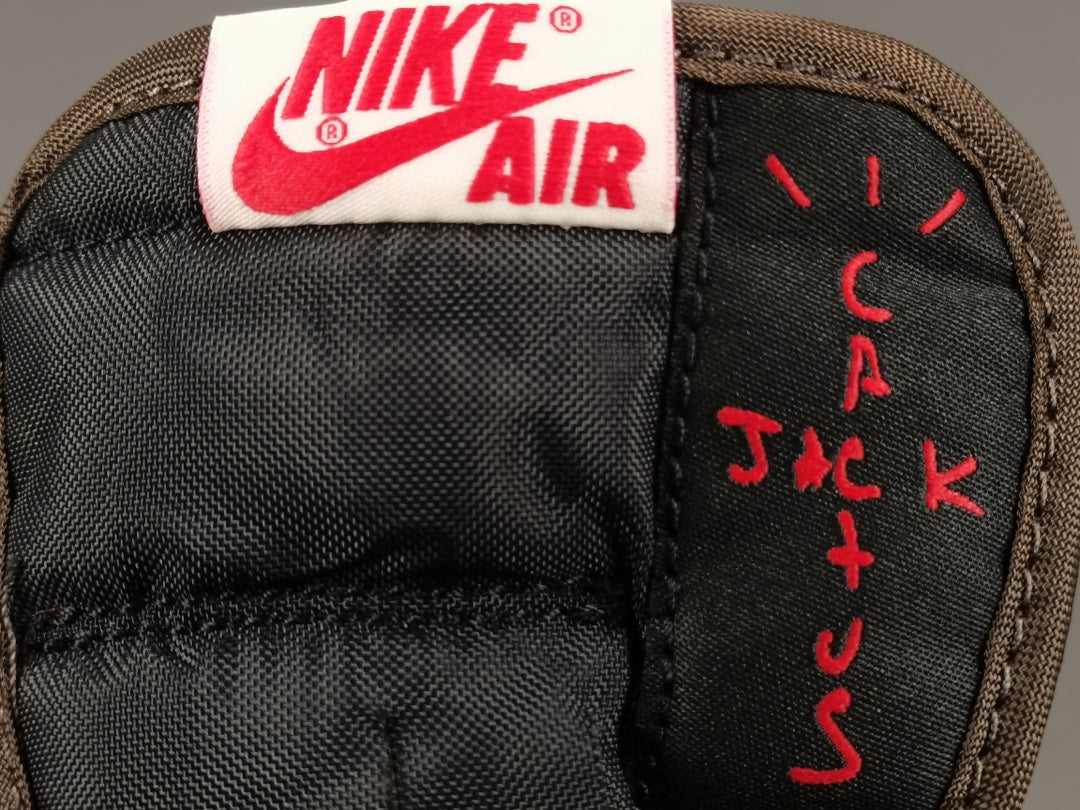 "Air Jordan 1 Low OG SP x Travis Scott sneakers featuring signature reverse Swoosh, premium materials, and Cactus Jack branding." 