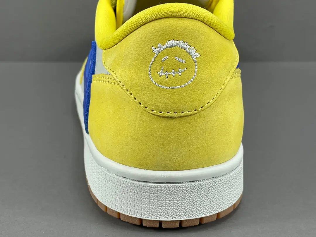 "Jordan 1 Low OG x Canary – low-top sneaker with premium leather upper, bright yellow and white colorway, and classic retro design."