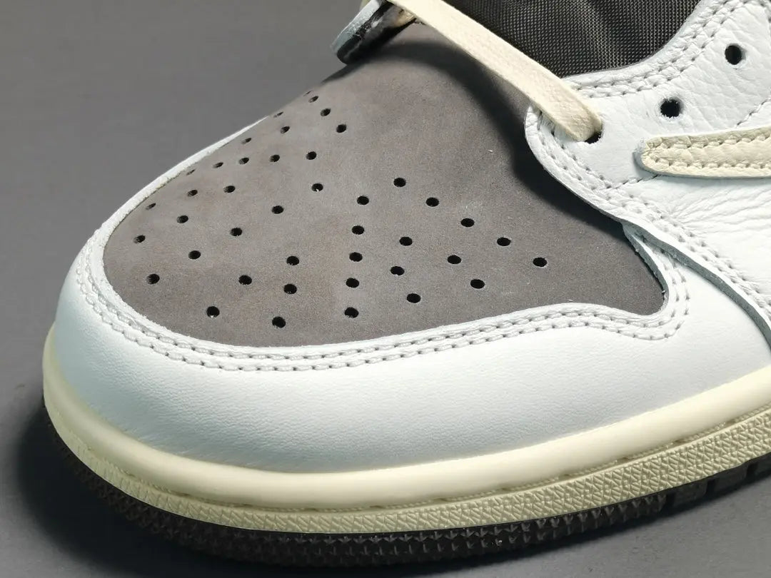 "Jordan 1 Low x Travis Scott Reverse Mocha – Mocha suede, reverse Swoosh, Cactus Jack branding, and vintage sail accents."