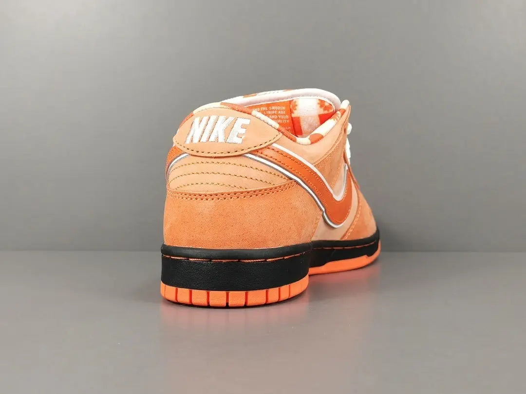 Nike SB Dunk heel view with reinforced stitching and vibrant orange accents