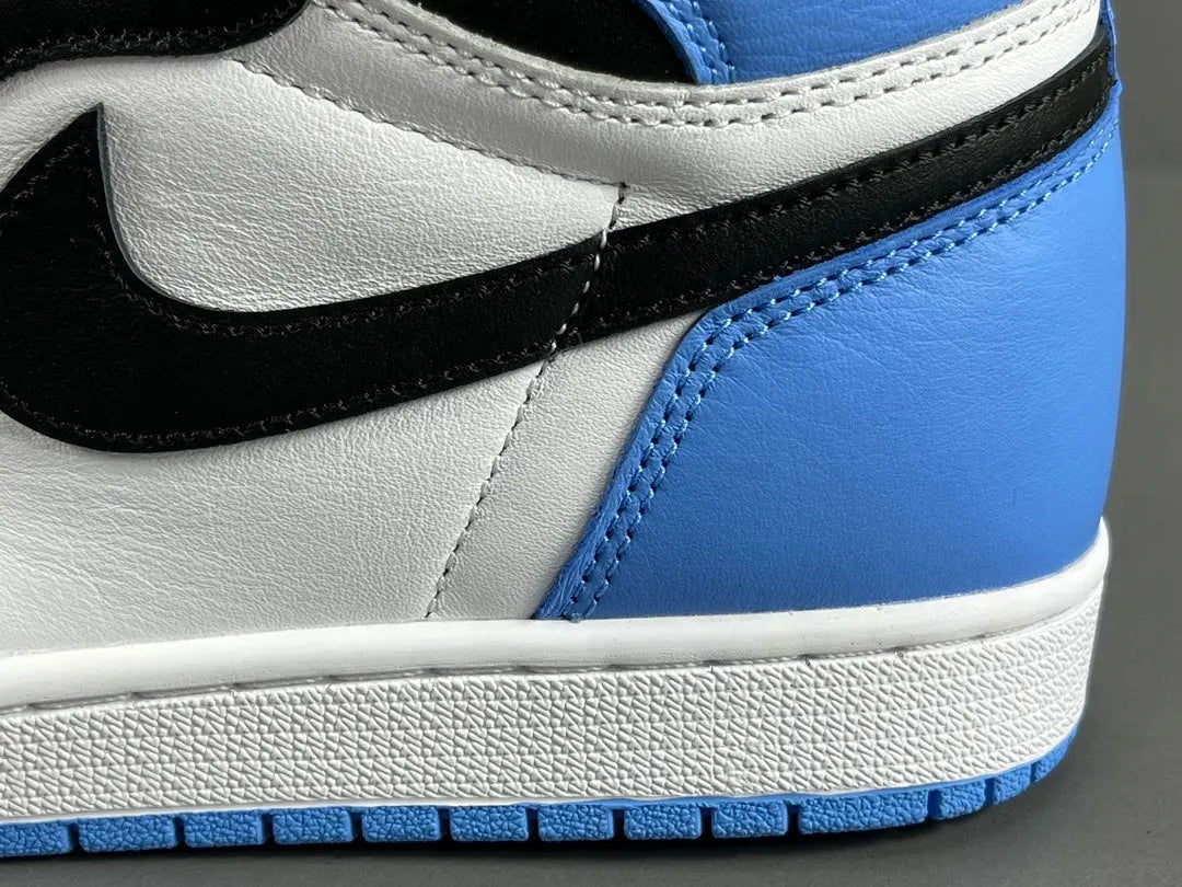 Air Jordan 1 High OG UNC Toe side view black white university blue sneaker