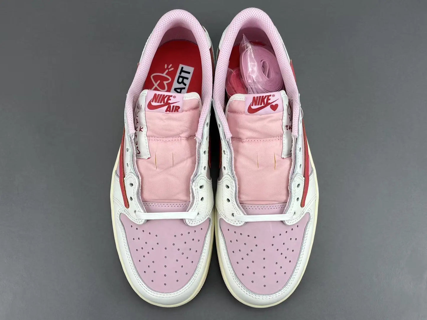 Jordan 1 Low Travis Scott Tropical Pink sneakers with reverse Swoosh
