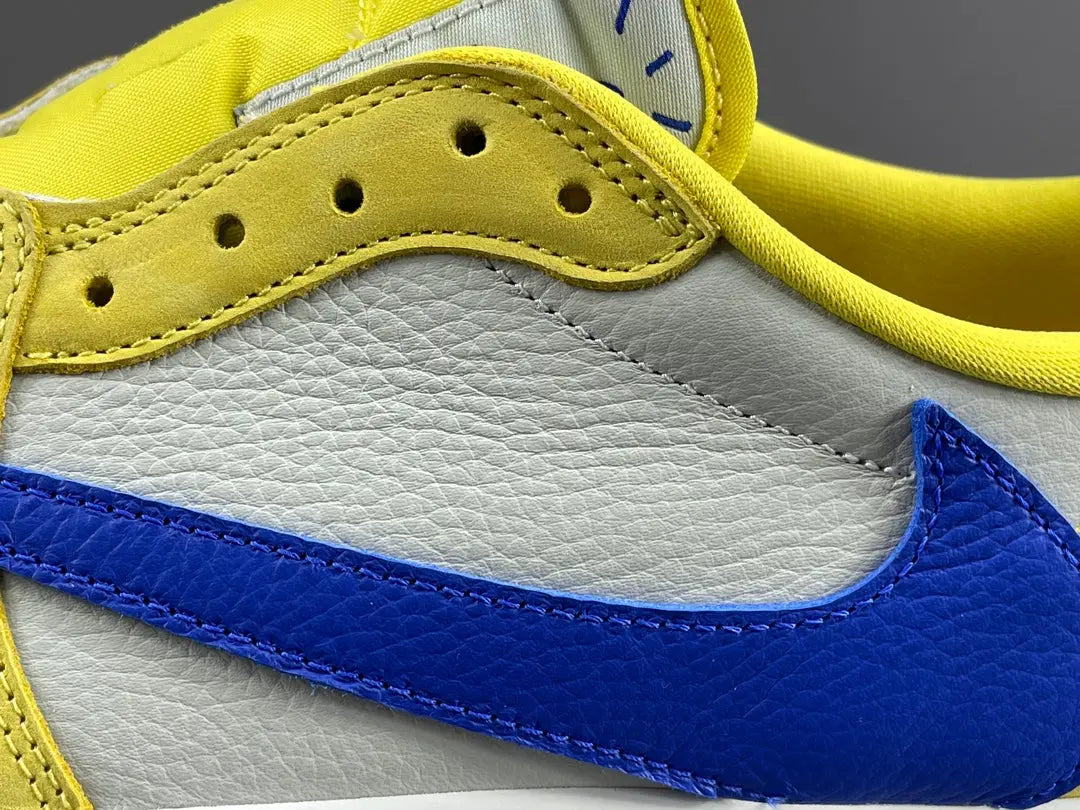"Jordan 1 Low OG x Canary – low-top sneaker with premium leather upper, bright yellow and white colorway, and classic retro design."