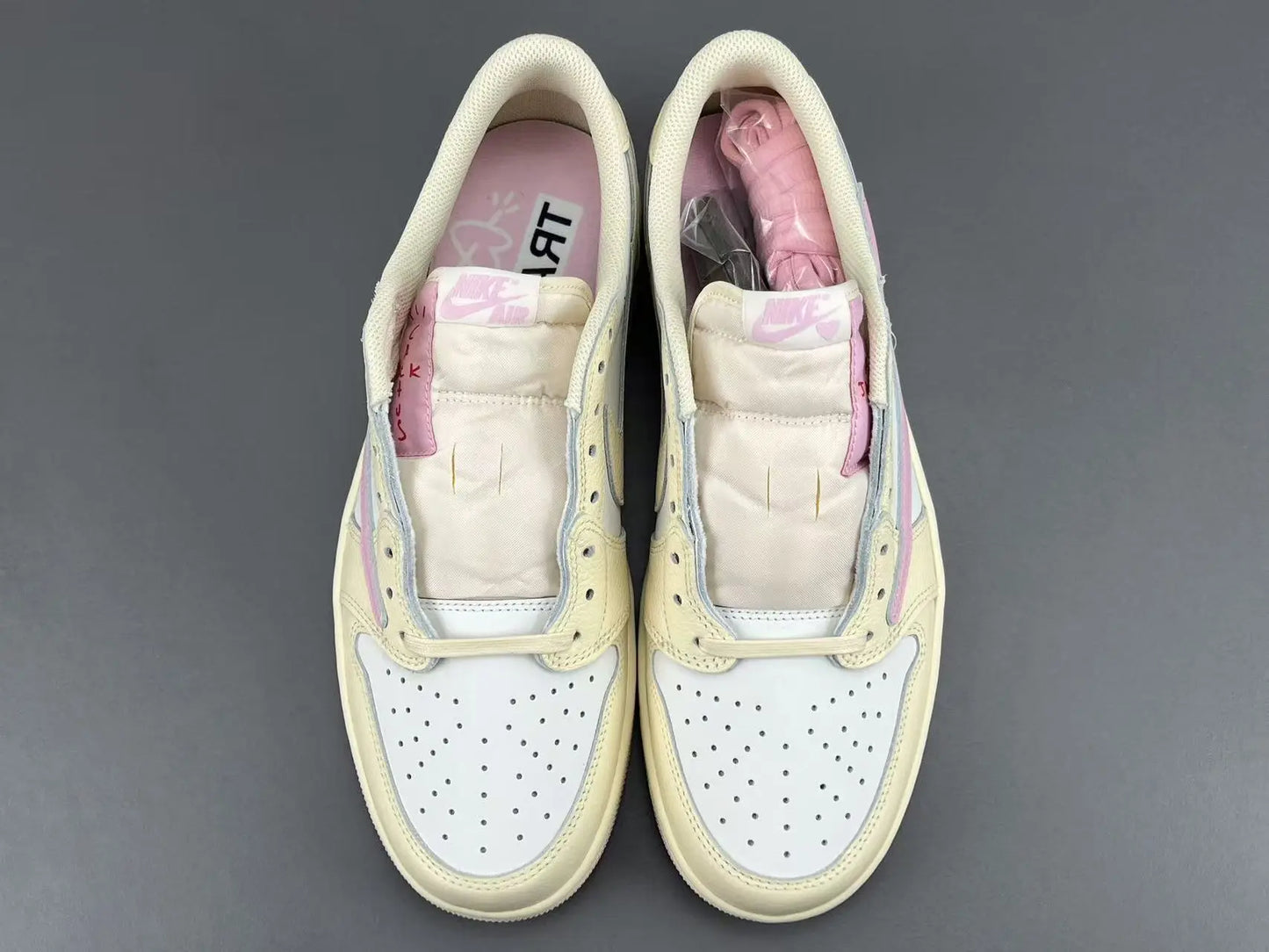 Jordan 1 Low Travis Scott Muslin Shy Pink sneakers with reverse Swoosh
