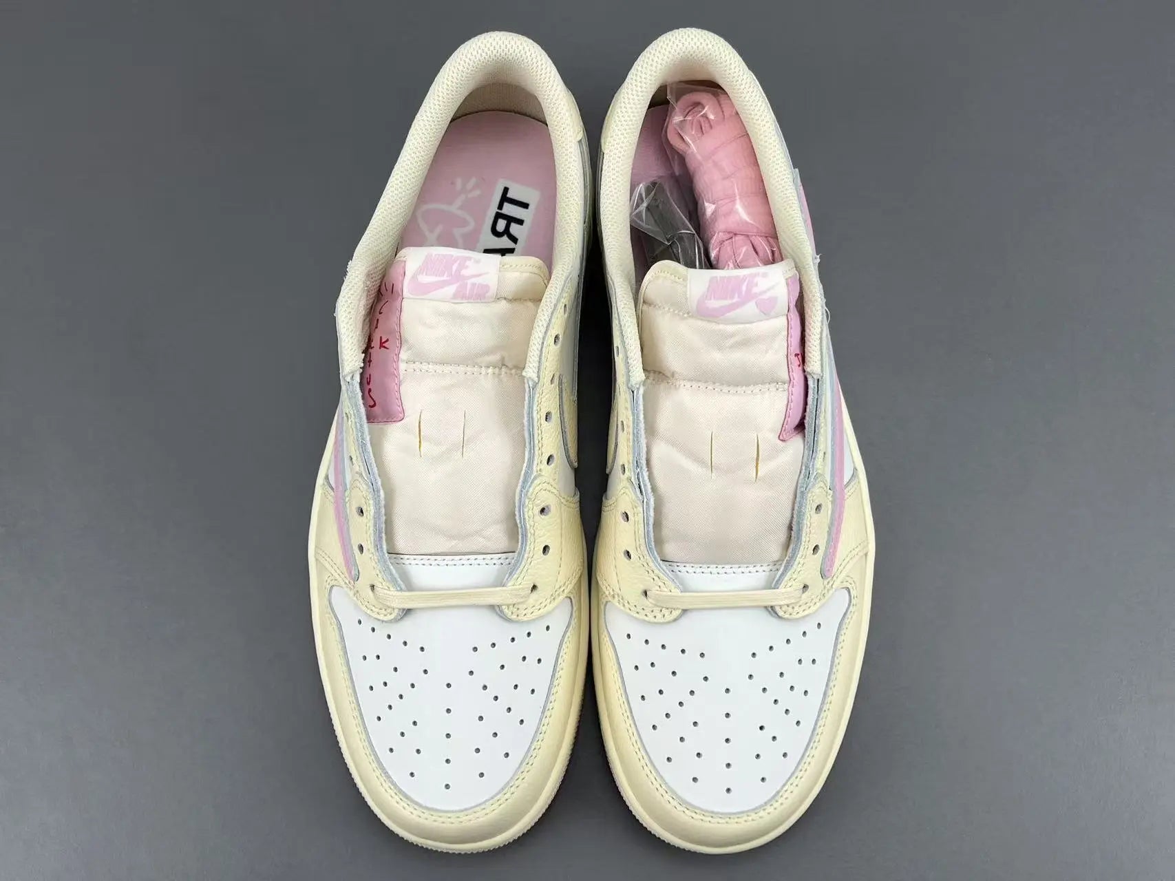 Jordan 1 Low Travis Scott Muslin Shy Pink sneakers with reverse Swoosh
