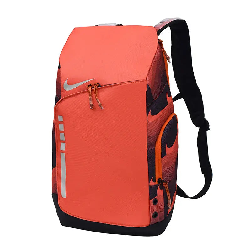 Nike athletic backpack in bright orange with black accents, featuring a large silver Nike swoosh on the front, reflective silver stripes, and black shoulder straps, shown on a plain white background.