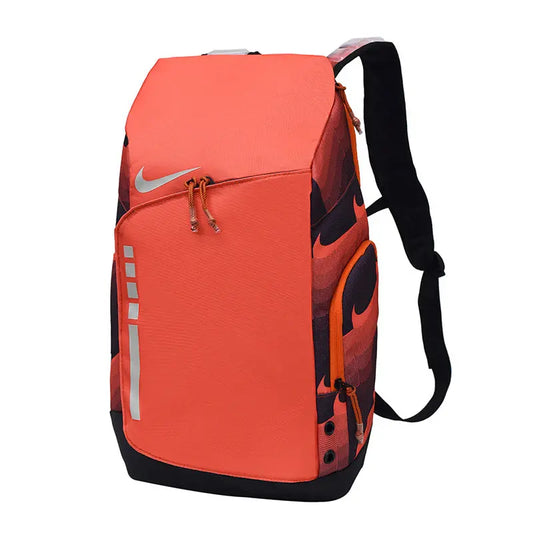 Nike athletic backpack in bright orange with black accents, featuring a large silver Nike swoosh on the front, reflective silver stripes, and black shoulder straps, shown on a plain white background.