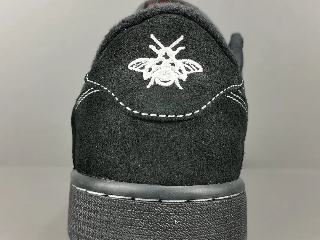 "Jordan 1 Low Travis Scott Phantom with black nubuck, white stitching, and signature reverse Swoosh."
