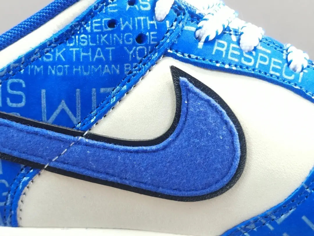 Nike Dunk Low “Jackie Robinson” sneaker with black, grey, and royal blue accents honoring the baseball legend
