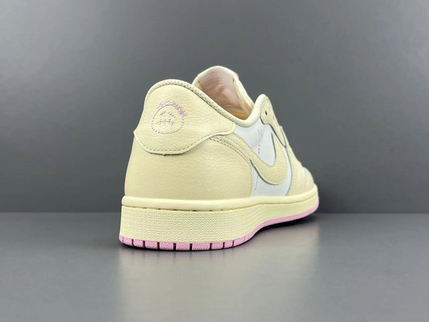 Jordan 1 Low Travis Scott Muslin Shy Pink sneakers with reverse Swoosh
