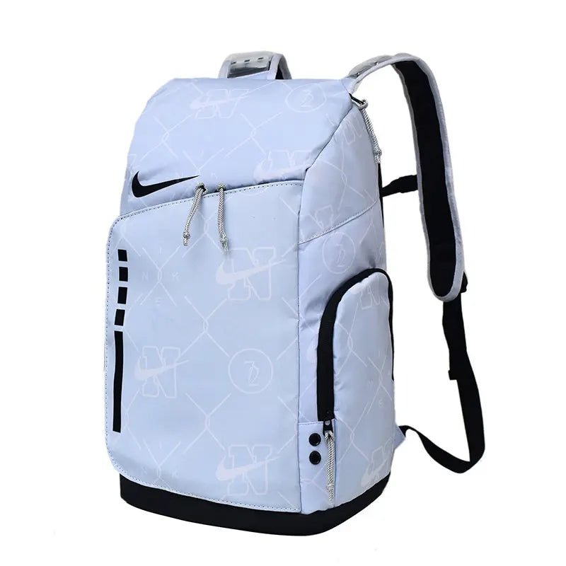 A light blue Nike backpack with black accents, featuring a subtle repeating logo pattern, a main zippered compartment, a front slip pocket, and a top carry handle, shown on a plain white background.