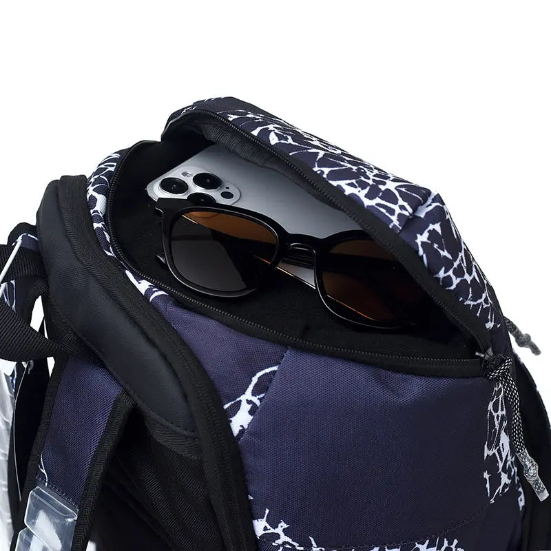 Close-up of a backpack opening with a black smartphone and black sunglasses inside, on a clean white background.