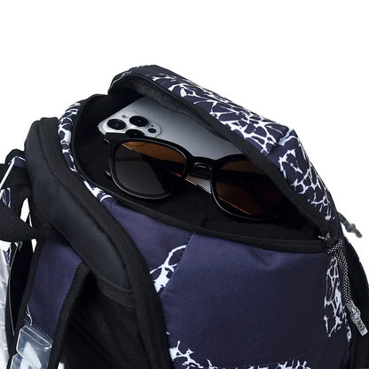Close-up of a backpack opening with a black smartphone and black sunglasses inside, on a clean white background.