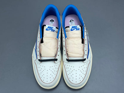Air Jordan 1 Low OG x Travis Scott x Fragment with a white, black, and blue design, reverse Swoosh, and co-branded heel logos.