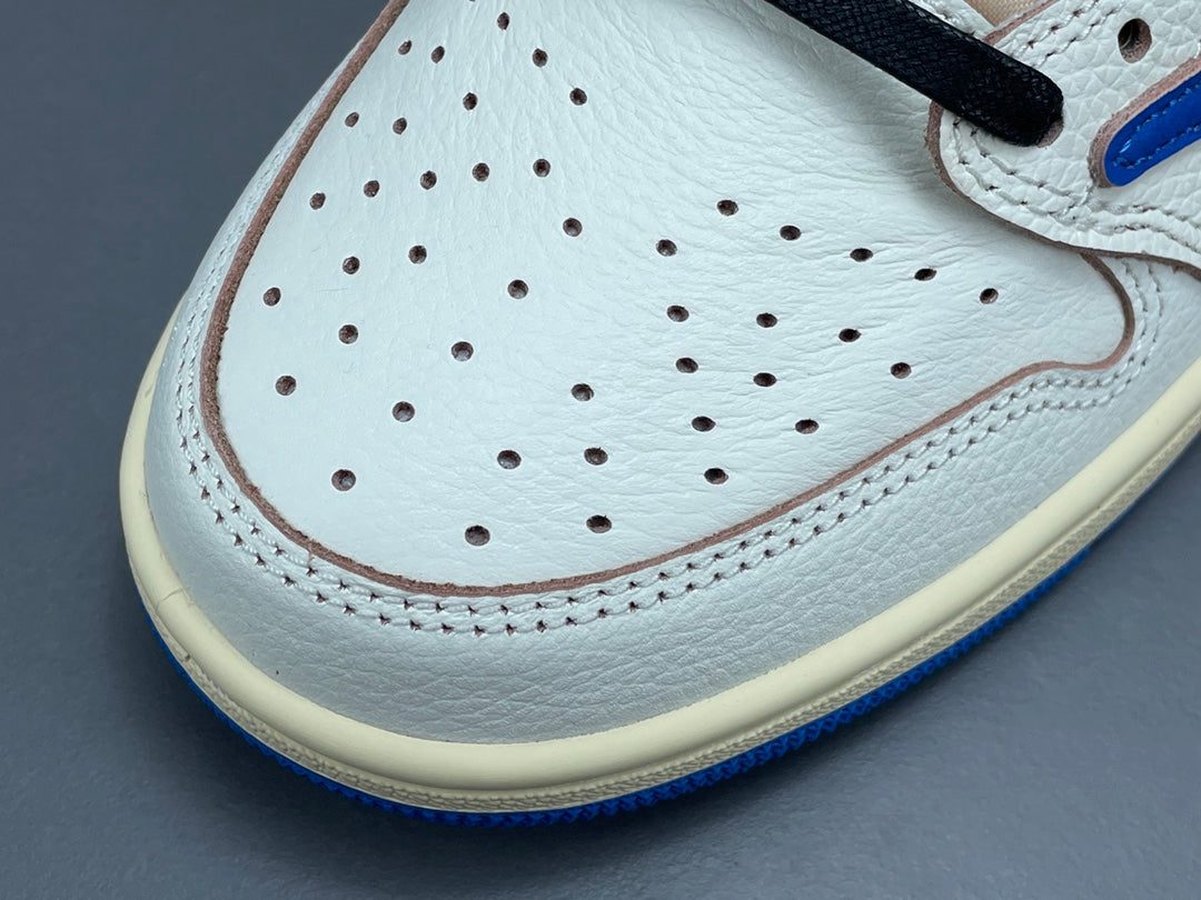 Air Jordan 1 Low OG x Travis Scott x Fragment with a white, black, and blue design, reverse Swoosh, and co-branded heel logos.