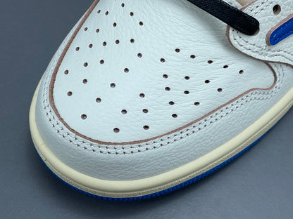 Air Jordan 1 Low OG x Travis Scott x Fragment with a white, black, and blue design, reverse Swoosh, and co-branded heel logos.