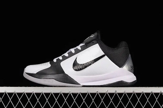 Side view of Nike Kobe 5 Protro in White/Black colorway showing the low-profile silhouette, black Nike Swoosh, and synthetic upper with fused overlays
