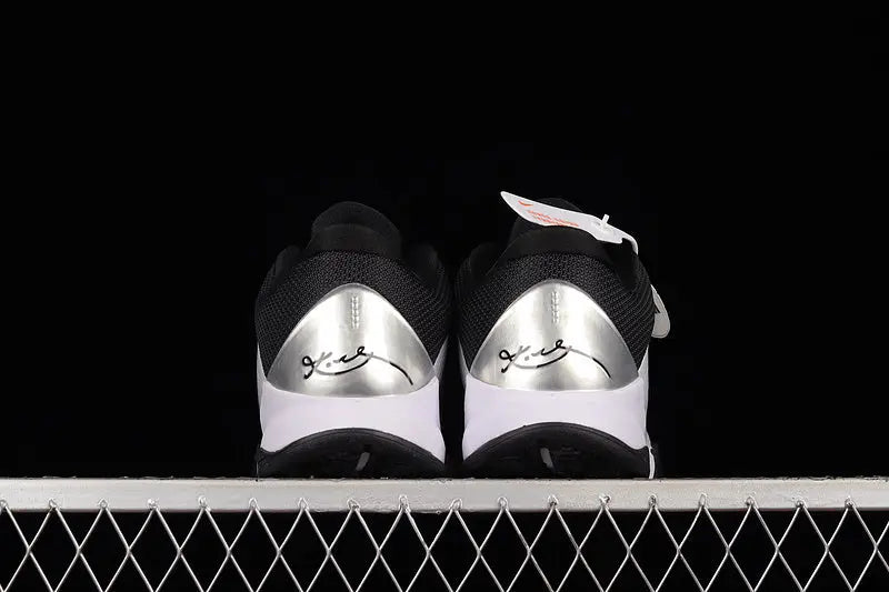 Heel detail of Nike Kobe 5 Protro White/Black basketball shoes highlighting the black heel counter, external support, and clean white-to-black color blocking