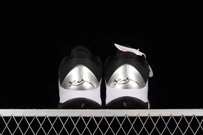 Heel detail of Nike Kobe 5 Protro White/Black basketball shoes highlighting the black heel counter, external support, and clean white-to-black color blocking