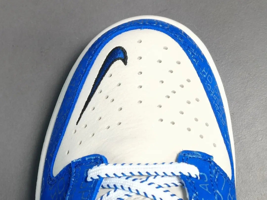 Nike Dunk Low “Jackie Robinson” sneaker with black, grey, and royal blue accents honoring the baseball legend
