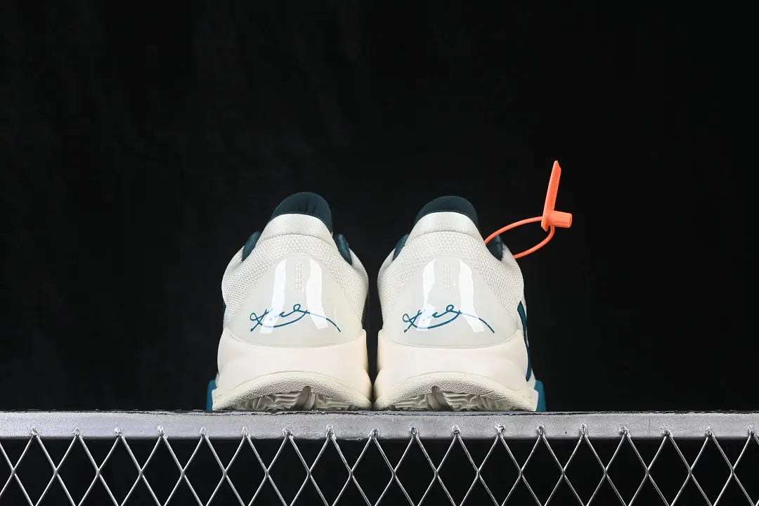 Heel view of Caitlin Clark Nike Kobe 5 Protro Coconut Milk Bright Spruce shoes