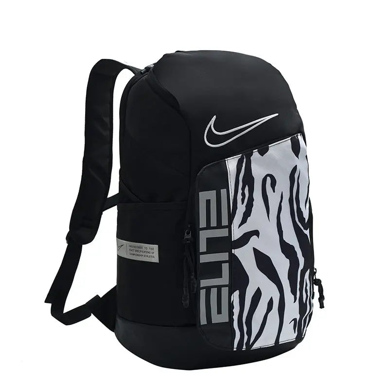 A black Nike backpack with a white swoosh logo and a bold black and white zebra-like patterned front pocket featuring the word 'ELITE' in gray.