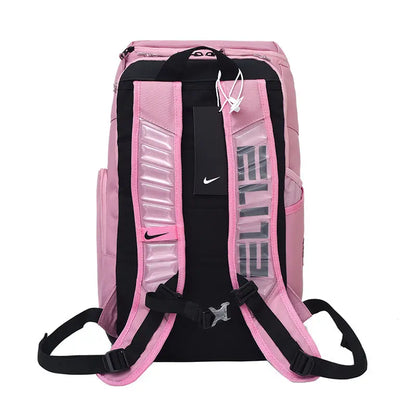 Pink and black Nike backpack shown from the back, featuring padded shoulder straps, a black hangtag, and reflective vertical text on the back panel.
