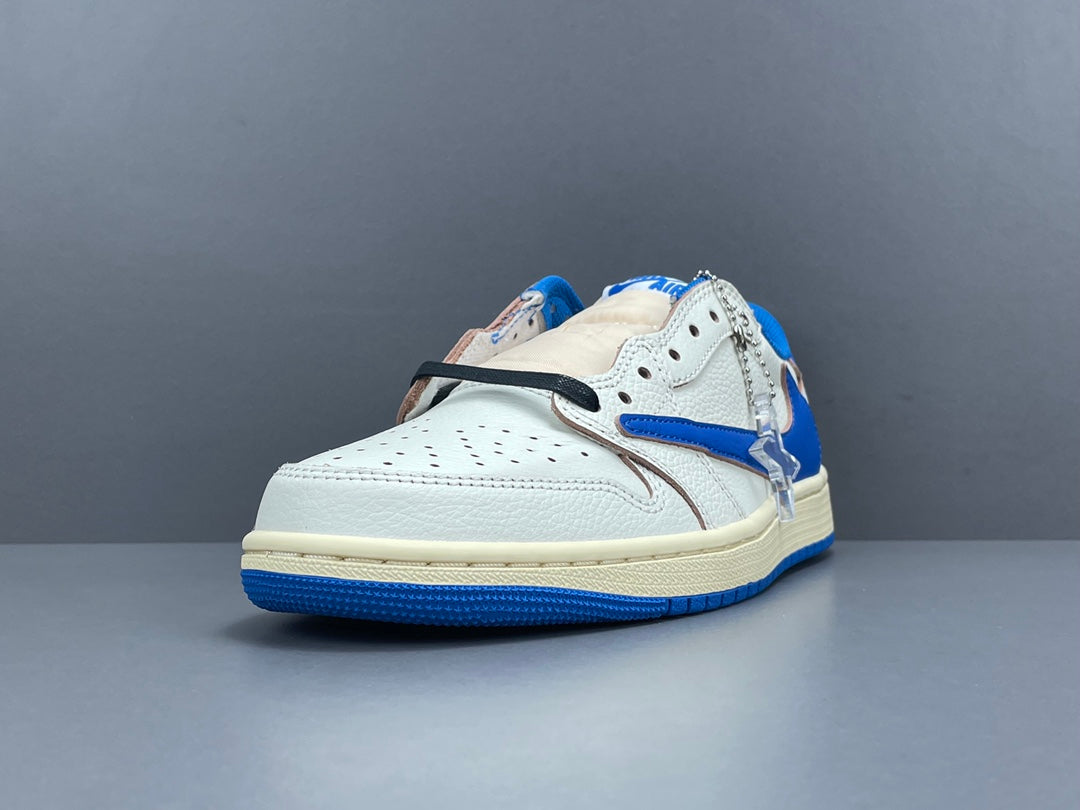Air Jordan 1 Low OG x Travis Scott x Fragment with a white, black, and blue design, reverse Swoosh, and co-branded heel logos.