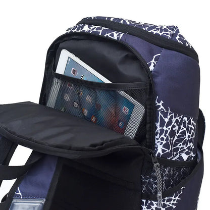A close-up of a backpack's open front pocket showing a tablet inside, with navy blue, black, and white patterned fabric panels and mesh pockets on a white background.