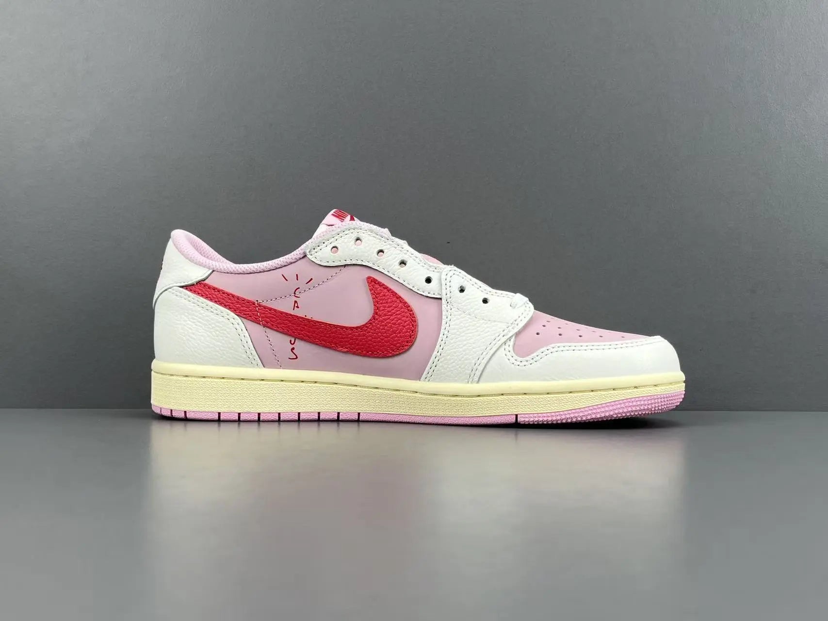 Jordan 1 Low Travis Scott Tropical Pink sneakers with reverse Swoosh
