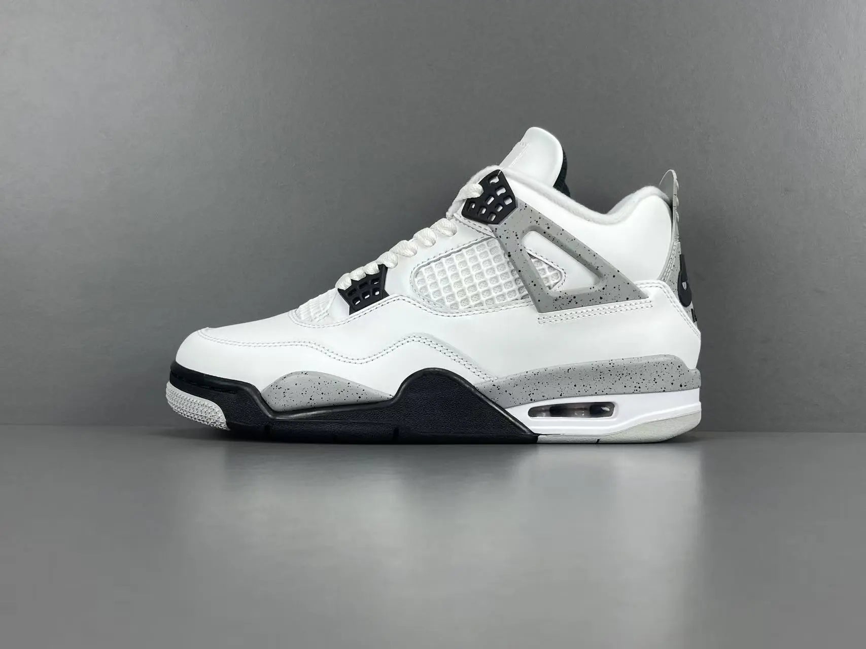Air Jordan 4 White Cement sneakers with iconic cement print and design

