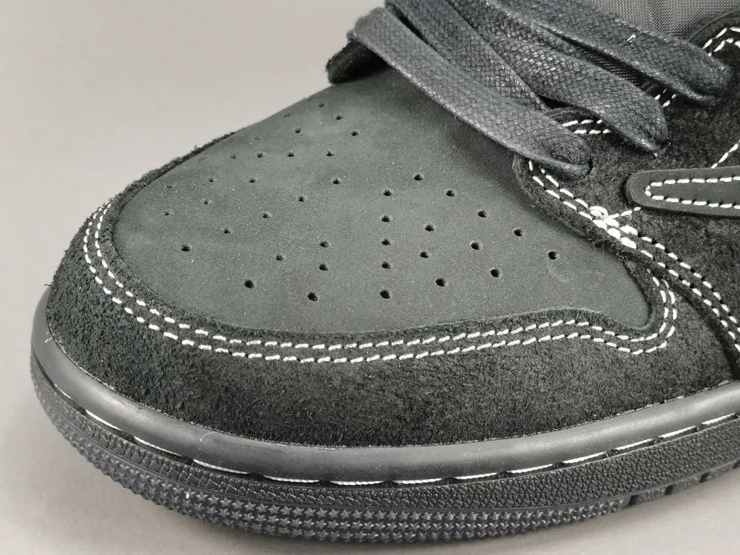 "Jordan 1 Low Travis Scott Phantom with black nubuck, white stitching, and signature reverse Swoosh."