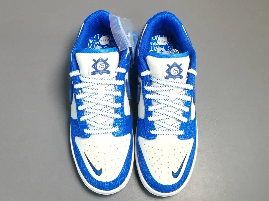 Nike Dunk Low “Jackie Robinson” sneaker with black, grey, and royal blue accents honoring the baseball legend
