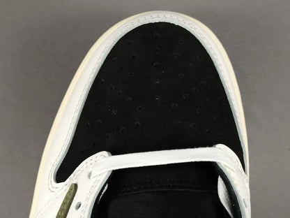"Jordan 1 Low x Travis Scott Olive with olive suede, black leather overlays, reverse Swoosh, and Cactus Jack branding."