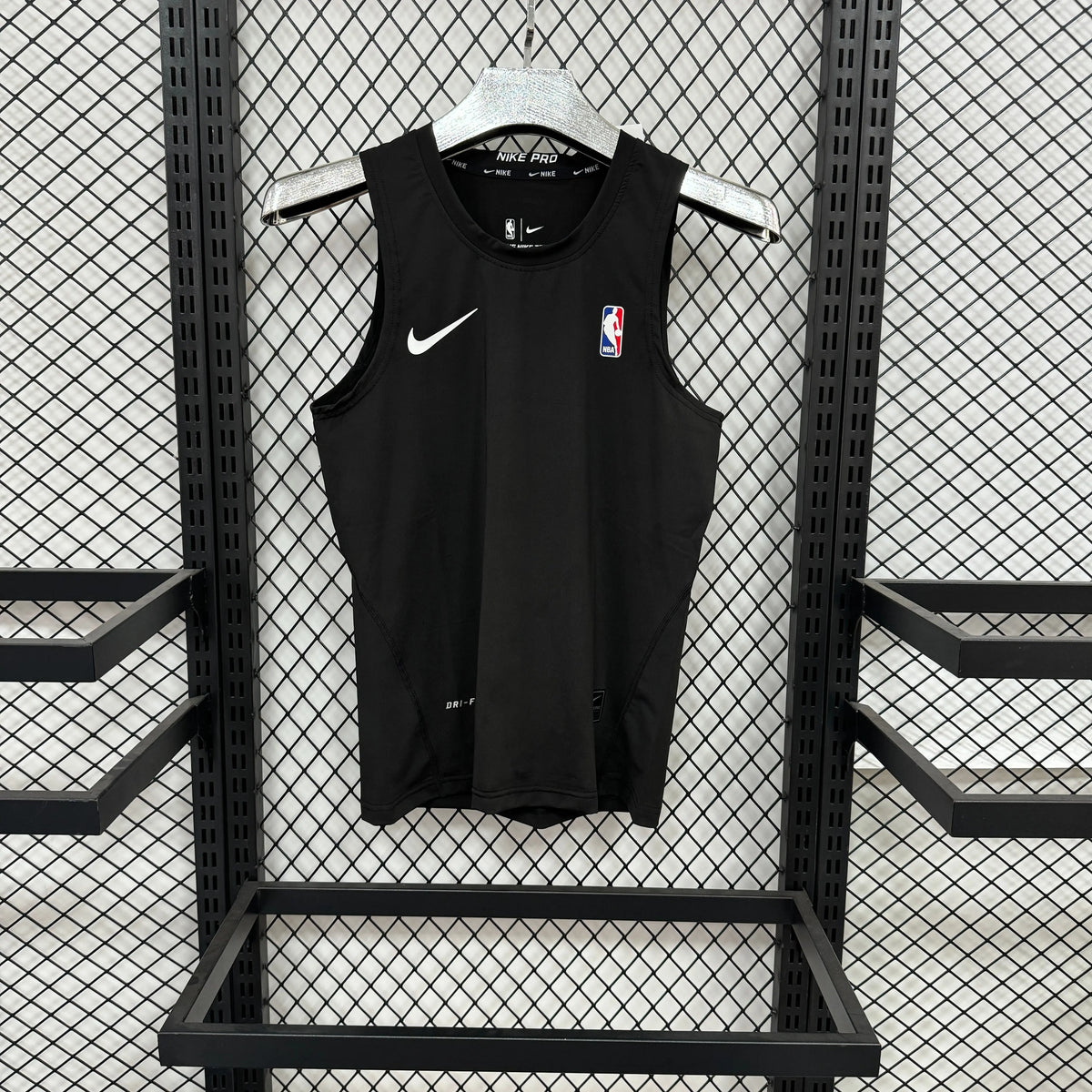A black Nike sleeveless basketball jersey with a white swoosh and an NBA logo on the chest, hanging on a white hanger against a black metal mesh display wall.